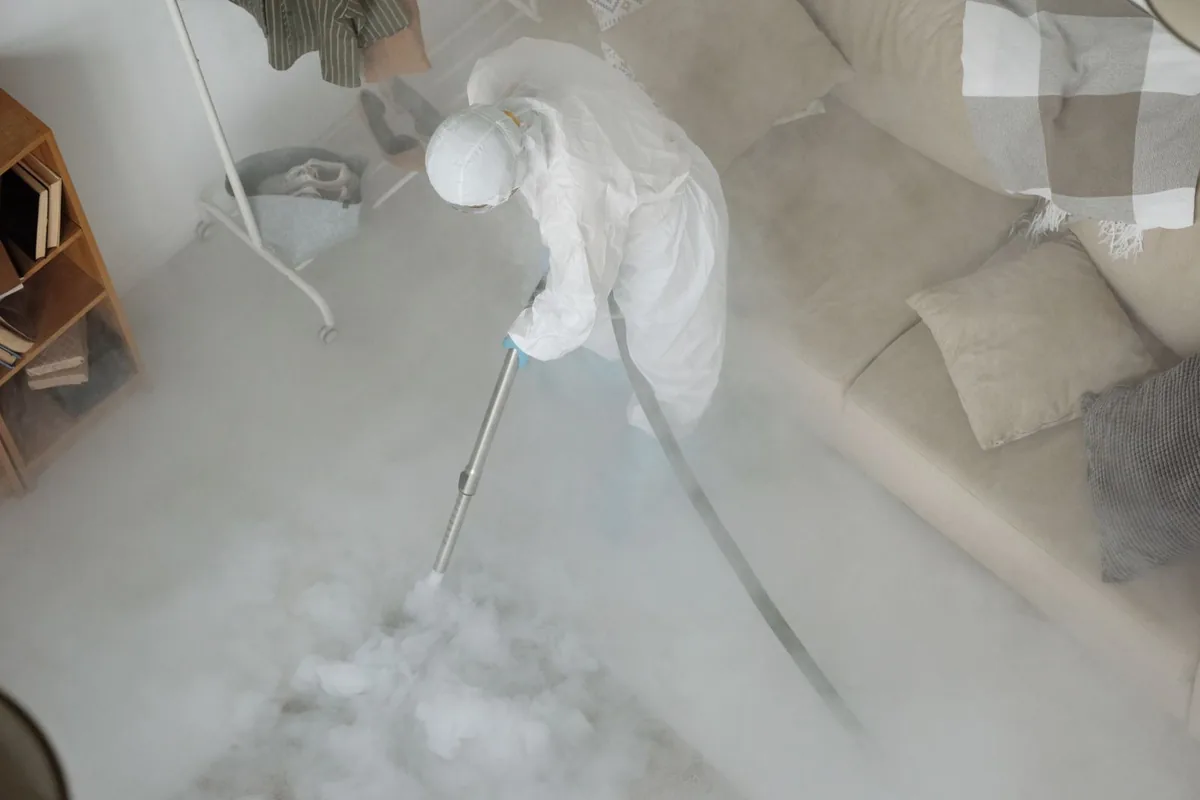Biohazard cleanup technician in protective equipment, Pevely, MO